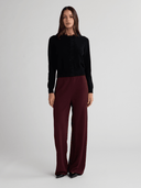 Full-length front view of women's black cashmere button-front cardigan
